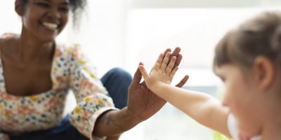 Multiracial family at home doing a high five