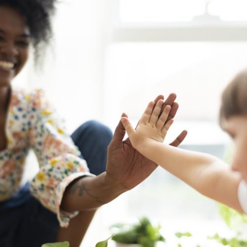 Multiracial family at home doing a high five